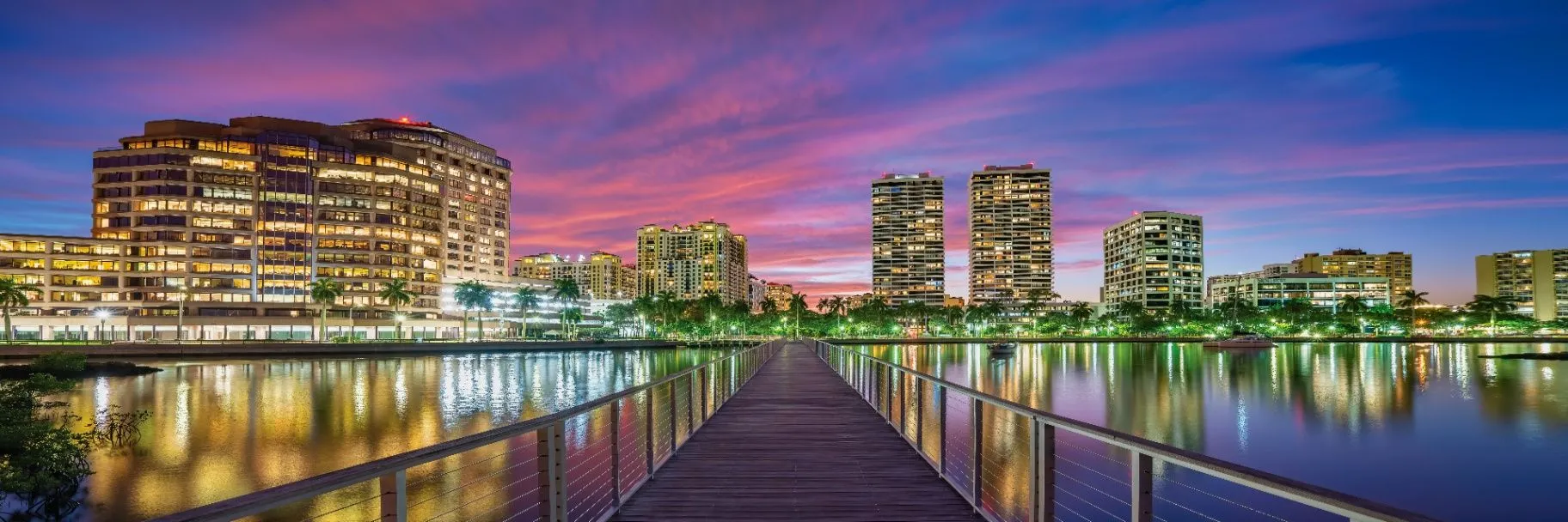 Palm Beach County waterfront skyline reflected in calm water at dusk